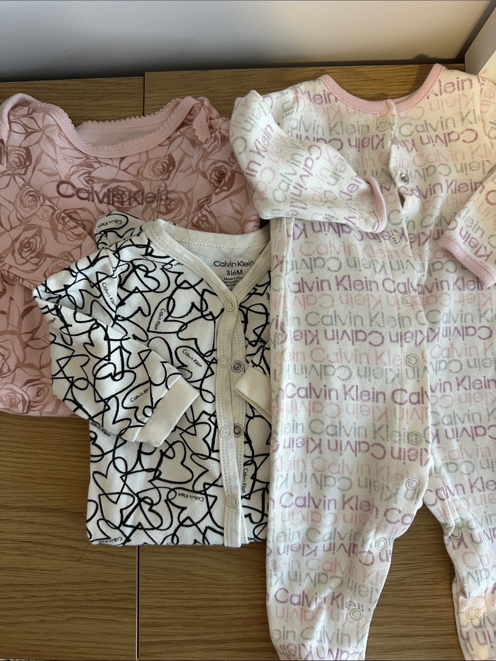 Bundle of Calvin Klein Baby Girls Footed One-Piece Pyjamas floral logo and heart